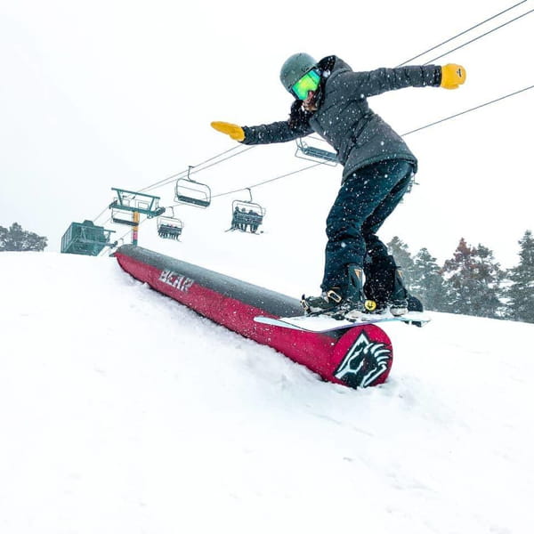 Snowboarder on a red rail